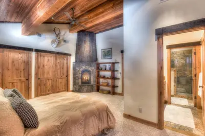 a bedroom with a large bed and a fireplace at Ridge Court Barrel - Relax in Private Hot Tub in Olympic Valley