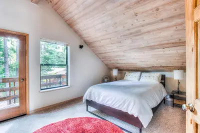 a bedroom with a bed and a wooden ceiling at Relax at Rustic Tahoe Charm - Minutes to Lake in Tahoma