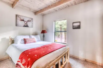 a bedroom with a large bed and a window at Relax at Rustic Tahoe Charm - Minutes to Lake in Tahoma