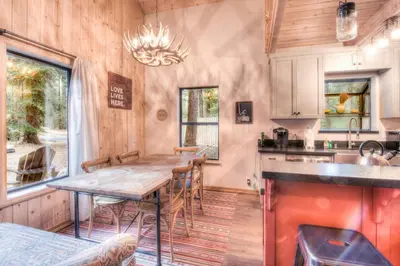 a kitchen with a wooden table and chairs in a room at Relax at Rustic Tahoe Charm - Minutes to Lake in Tahoma