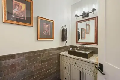 a bathroom with a sink and some pictures on the wall at Serenity on Statford - Close to Northstar in Tahoe Vista
