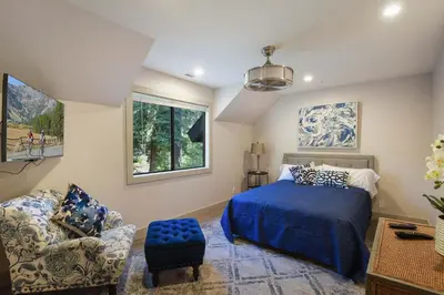 a bedroom with a bed and a chair at Serenity on Statford - Close to Northstar in Tahoe Vista