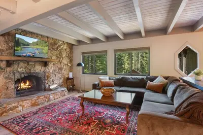 a living room with a couch and a fireplace at Serenity on Statford - Close to Northstar in Tahoe Vista