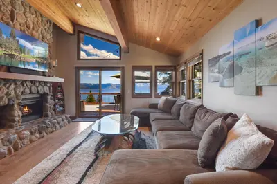 a living room with a couch and a fireplace at Shoreline Vista - Lake Views Near Hike & Bike in Carnelian Bay