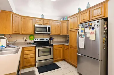a kitchen with wooden cabinets and a stainless steel refrigerator at Sierra Pines Retreat - Sleeps 6 in Incline Village
