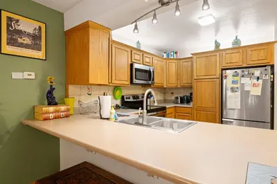 a kitchen with wooden cabinets and a white counter top at Sierra Pines Retreat - Sleeps 6 in Incline Village