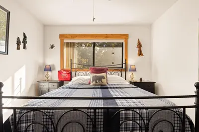 a bedroom with a large bed with a window at Sierra Pines Retreat - Sleeps 6 in Incline Village