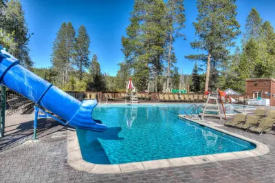 a swimming pool with a blue slide and a playground at Skislope Sanctuary - Close to Outdoor Activities in Truckee