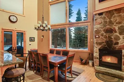 a dining room with a table and a fireplace at Skislope Sanctuary - Close to Outdoor Activities in Truckee