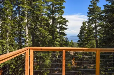 a deck with a view of the trees at Snowshoe Cabin - 3 Decks BBQ & Hot Tub in Tahoe City