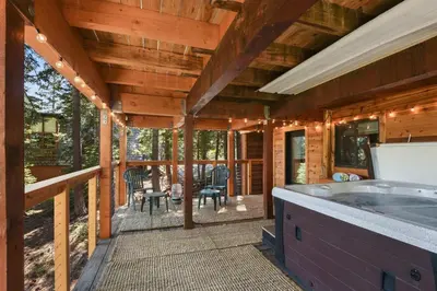 a porch of a cabin with a hot tub at Snowshoe Cabin - 3 Decks BBQ & Hot Tub in Tahoe City