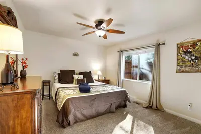 a bedroom with a bed and a ceiling fan at Tahoe Frost - Air conditioned 4 bedroom Tahoe home in South Lake Tahoe