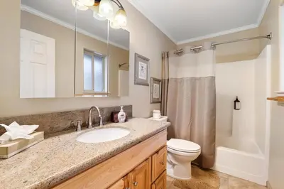 a bathroom with a sink and a toilet and a shower at Tahoe Frost - Air conditioned 4 bedroom Tahoe home in South Lake Tahoe