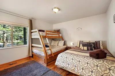 a bedroom with two bunk beds and a window at Tahoe Frost - Air conditioned 4 bedroom Tahoe home in South Lake Tahoe
