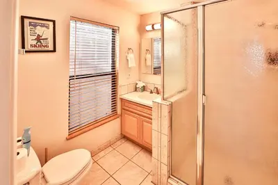 a bathroom with a shower and a toilet and a sink at Tahoe Lakeside Retreat - Lakefront Condo in South Lake Tahoe