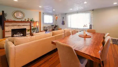a living room with a table and a couch and a fireplace at Tahoe Trail Retreat - Steps from the TRT in Zephyr Cove