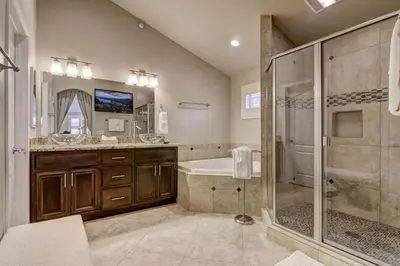 a bathroom with a shower and a tub and a sink at Tahoe Woods Heavenly - Walk to beach & Gondola to Heavenly Ski in South Lake Tahoe