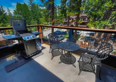 a patio with a grill and tables and chairs on a balcony at Tahoe Woods Heavenly - Walk to beach & Gondola to Heavenly Ski in South Lake Tahoe