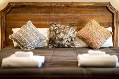 a bed with several pillows on top of it at Tahoe Woods Villa - Walk to Beach and Gondola - Heavenly Ski in South Lake Tahoe
