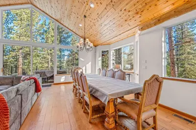 a dining room with a table and a couch at The Lodge on Oaxaco - Epic Man Cave with Billiard Room in South Lake Tahoe