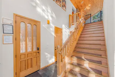a staircase in a house with a wooden door at The Lodge on Oaxaco - Epic Man Cave with Billiard Room in South Lake Tahoe