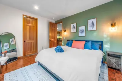 a bedroom with a large bed and a fireplace at The Lodge on Oaxaco - Epic Man Cave with Billiard Room in South Lake Tahoe
