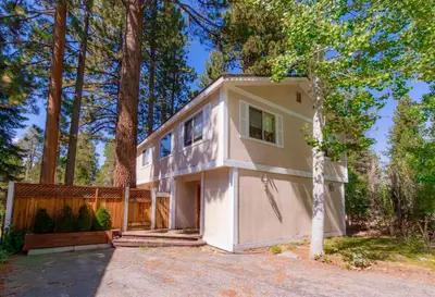 a small white house in the woods at The Meadows - Ski Lease - Extended 30 Plus Days in South Lake Tahoe