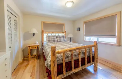 a bedroom with a bed with a wooden frame and a window at The Meadows - Ski Lease - Extended 30 Plus Days in South Lake Tahoe