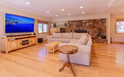 a living room with a white couch and a tv at The Meadows - Ski Lease - Extended 30 Plus Days in South Lake Tahoe