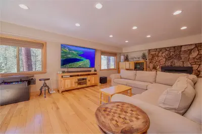 a living room with a couch and a tv at The Meadows - Ski Lease - Extended 30 Plus Days in South Lake Tahoe