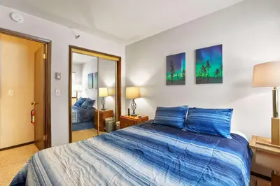 a bedroom with a large bed with blue pillows at Valley View - Carson Valley Views in Stateline