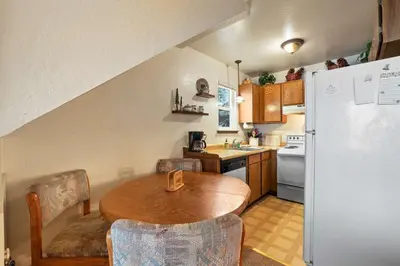 a kitchen with a wooden table and a refrigerator at Valley View - Carson Valley Views in Stateline