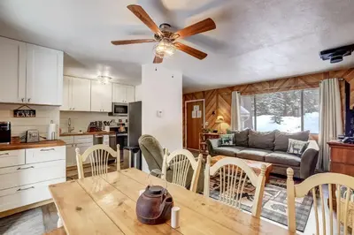 a kitchen and living room with a table and chairs at Whispering Pines Cabin - Family & Pet Friendly Abode in South Lake Tahoe