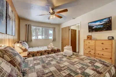 a bedroom with two beds and a ceiling fan at Whispering Pines Cabin - Family & Pet Friendly Abode in South Lake Tahoe