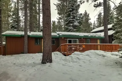 a cabin in the woods in the snow at Whispering Pines Cabin - Family & Pet Friendly Abode in South Lake Tahoe