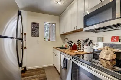 a kitchen with a stove and a refrigerator at Whispering Pines Cabin - Family & Pet Friendly Abode in South Lake Tahoe