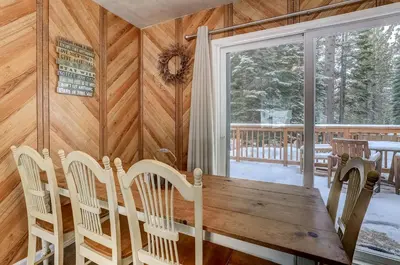 a dining room with a wooden table and chairs at Whispering Pines Cabin - Family & Pet Friendly Abode in South Lake Tahoe