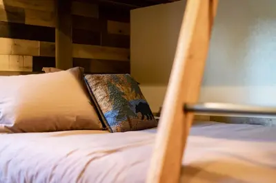 a bunk bed with a pillow on top of it at Willow's Hideaway - Pet Friendly Cozy Cabin in South Lake Tahoe
