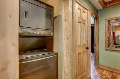 a kitchen with a dishwasher and a large television at Willow's Hideaway - Pet Friendly Cozy Cabin in South Lake Tahoe