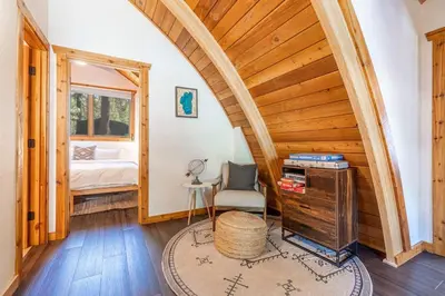a room with a bed and a table and a chair at Canoe Cabin I Sleeps 8 I Hot Tub I Pet Friendly in Incline Village