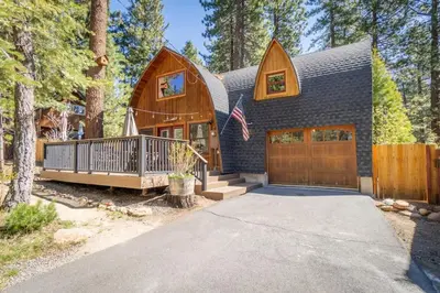 a house with a gambrel roof and a garage at Canoe Cabin I Sleeps 8 I Hot Tub I Pet Friendly in Incline Village