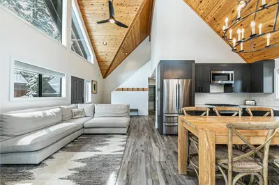 a living room with a couch and a table at Misty Pines by Tahoe Getaways at Tahoe Park - Newly Remodeled Pet Friendly 3 BR w Private Beach HOA in Tahoe City