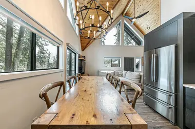 a dining room with a wooden table and chairs at Misty Pines by Tahoe Getaways at Tahoe Park - Newly Remodeled Pet Friendly 3 BR w Private Beach HOA in Tahoe City
