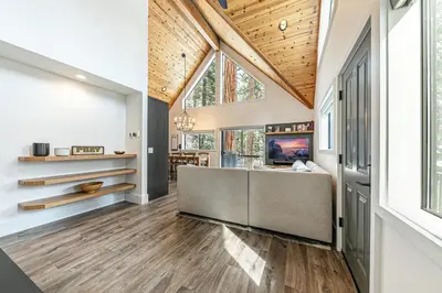 an open living room with a vaulted ceiling at Misty Pines by Tahoe Getaways at Tahoe Park - Newly Remodeled Pet Friendly 3 BR w Private Beach HOA in Tahoe City