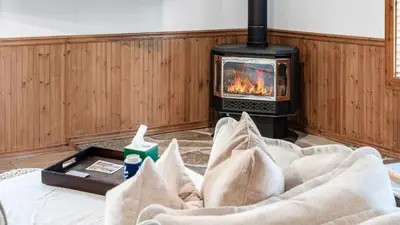 a living room with a bed with a fireplace at Geraldine Drive by AvantStay Hot Tub Views Walk to Trails Game Room in Incline Village