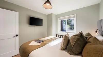 a bedroom with a bed with a television on the wall at Geraldine Drive by AvantStay Hot Tub Views Walk to Trails Game Room in Incline Village
