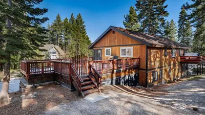 a home with a large deck and a house at Geraldine Drive by AvantStay Hot Tub Views Walk to Trails Game Room in Incline Village