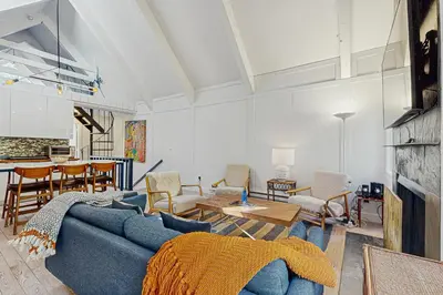 a living room with a blue couch and a table at Family Friendly! Incline Village Condo with Foosball in Tyrolian Village