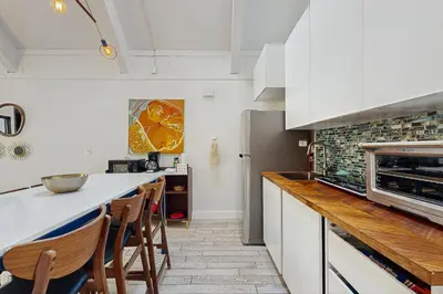 a kitchen with white cabinets and a counter with chairs at Family Friendly! Incline Village Condo with Foosball in Tyrolian Village
