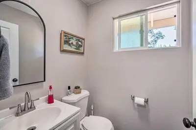 a bathroom with a sink and a toilet and a mirror at Beautiful Large close to Skiing / Wine Tasting! in Pioneer